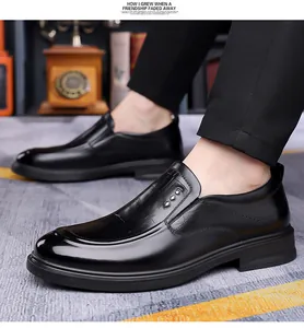 Detail view of black leather dress shoes with crocodile texture and silver buckles