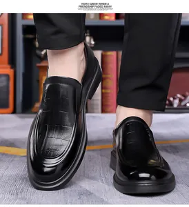 Detail of black loafers with crocodile pattern texture and polished leather finish