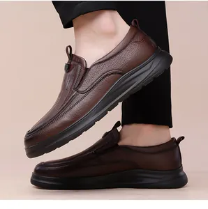 Detail view of brown pebble grain leather men's slip-on loafer with thick black sole