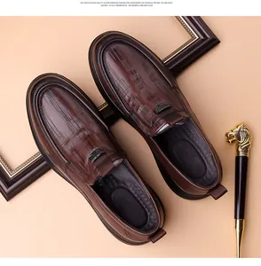 Detail of brown crocodile pattern leather loafer with metal buckle and soft sole