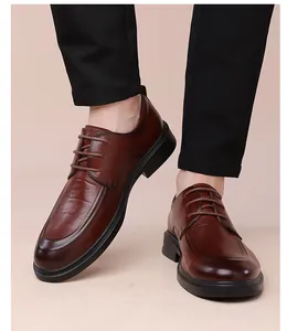 Detail view of brown crocodile texture leather derby shoes with thick rubber soles