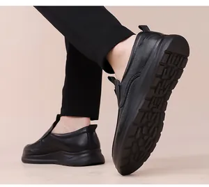 Close-up of black pebble leather slip-on shoes with durable anti-slip rubber soles