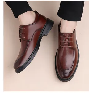 Detail of brown derby shoes featuring crocodile embossed leather and classic lacing system