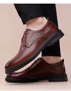 Detail view of brown leather derby shoe with brogue patterns and thick rubber sole