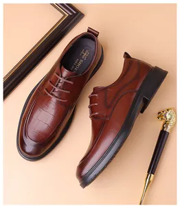 Close-up of brown derby shoe with crocodile embossed toe and brogue detail