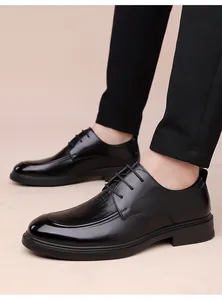 Detail of men's black derby shoes featuring crocodile embossed leather and brogue texture