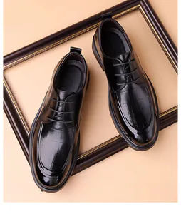 Close-up of black derby dress shoes featuring crocodile-patterned leather and smooth finish