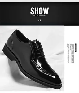Close-up of black patent leather brogue shoes with elegant decorative perforations