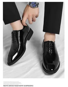 Close-up of polished black patent leather square toe business shoes with lace-up detail
