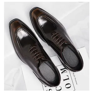 Detailed close-up of brown leather brogue shoes with square toe and gradient finish