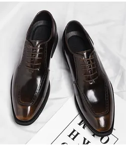 Detail view of dark brown gradient leather oxfords with brogue wingtip patterns