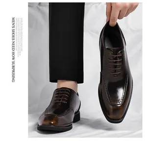 Detail shot of men's dark brown brogue shoes with carved patterns and square toe