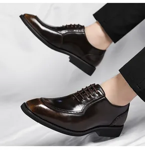 Detail of deep brown glossy leather derby shoe with brogue patterns and thick rubber sole