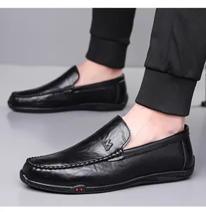 Detail of black leather loafers with M FASHION metal logo and stylish red dot sole detail