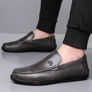 Men's dark gray loafers with pebbled leather texture and metal buckle detail