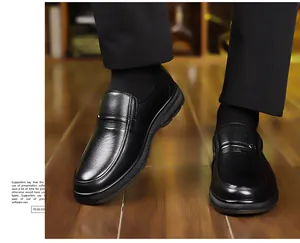 Dettaglio di scarpe slip-on in pelle nera con trama litchi e cuciture laterali