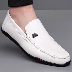 White leather driving loafers for men featuring hand-stitched details and rubber soles