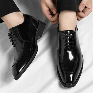 Polished black patent leather oxford shoes for men with classic brogue wingtip details