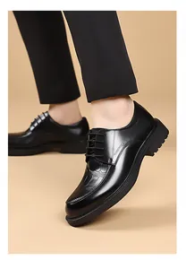 Detail of black leather Derby shoes with crocodile pattern texture and thick rubber sole