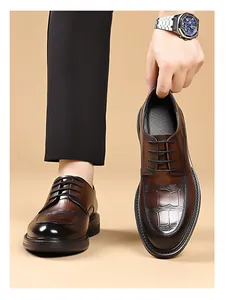 Detail of brown crocodile embossed leather oxfords with elegant black gradient toe