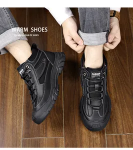 Detail of black leather lace-up winter boots with white stitching and chunky non-slip soles