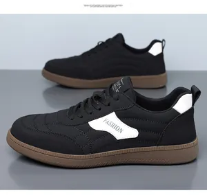 Detail of black suede casual sneakers with caramel gum sole and streamline stitching