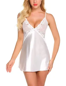 Detailed close-up of white satin nightdress featuring delicate lace embroidery and V-neckline