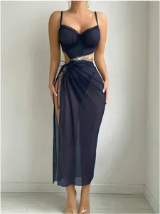 Detail of sheer navy mesh lingerie dress featuring waist cut-outs and gold chain accents