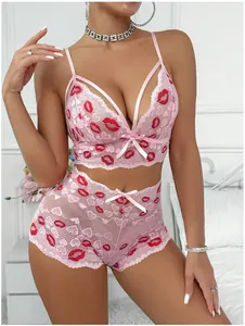 Détail d'un ensemble de lingerie en dentelle rose avec imprimés lèvres rouges