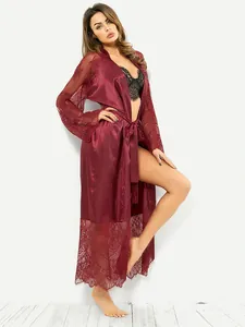 Détail du peignoir en satin bordeaux avec des finitions en dentelle aux manches et à l'ourlet