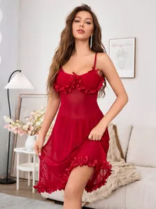 Detail of red mesh nightgown showing intricate 3D lace floral embroidery and sheer fabric