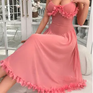 Pink mesh see-through lingerie nightgown with floral appliques on a model by a window