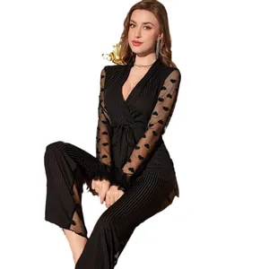 Sexy black mesh jumpsuit with heart patterns, V-neck, and feathered cuffs for women