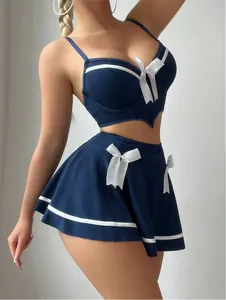 Detail of navy blue lingerie set with white contrast trim and decorative bows