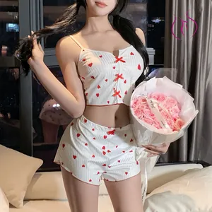 Detail of red heart print and bow accents on white ribbed pajama camisole set