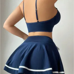 Navy blue two-piece schoolgirl lingerie set with cropped camisole and pleated mini skirt
