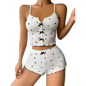 Women's white two-piece pajama set with heart print, ribbon bows, and lettuce trim