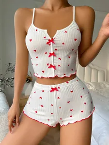 Close-up of heart print ribbed pajama set with bow detail and wavy hemline texture