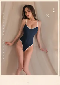 Close-up of navy blue teddy lingerie with white contrast trim and sleek elastic fabric