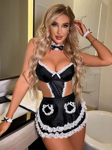 Detail of maid cosplay set with black satin, white lace trim and bow on marble background