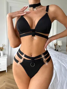 Detail of black lingerie set with silver O-ring accents and multi-strap design