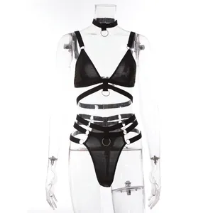 Detail of black mesh lingerie set featuring metal rings and strappy harness design