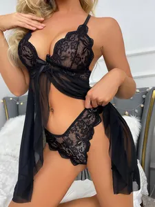 Detail of black floral lace embroidery and sheer mesh on a sexy two-piece lingerie set