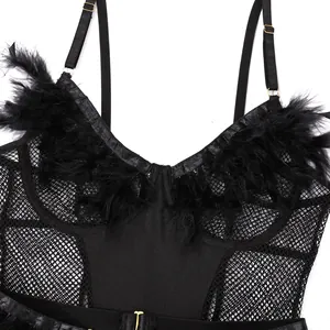 Close-up of black mesh bodysuit featuring plush feather trim and adjustable gold buckles