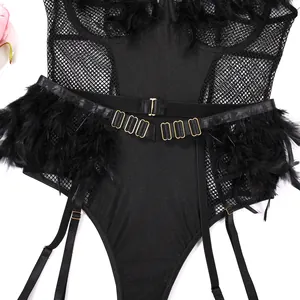 Detailed close-up of black mesh lingerie with plush feather trim and gold buckles