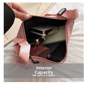 Internal capacity of pink nylon crossbody bag showing phone and cosmetics layout