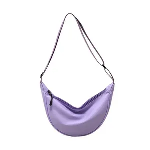 Minimalist light purple nylon crescent crossbody bag with adjustable strap and zip closure
