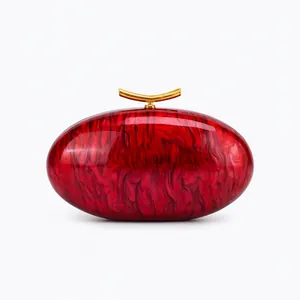 Macro view of red marble acrylic shell with premium gold metallic clasp closure