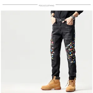 Slim fit zwarte herenjeans met distressed details en kleurrijke verfspatten voor heren