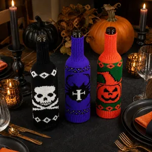 Macro detail of Halloween knitted wine bottle covers with skull and pumpkin patterns